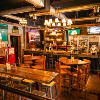 Pub interior with bar seating and warm lighting.