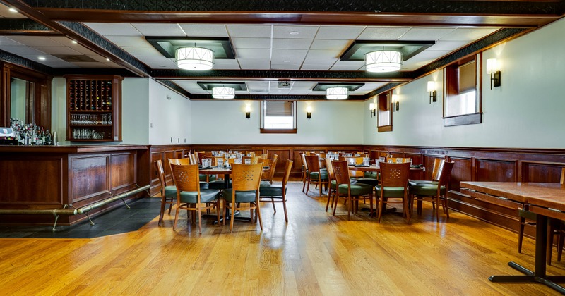 Dining room with wooden flor, tables and chairs