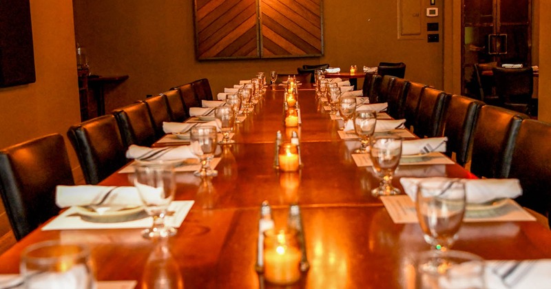 Interior, tables set with plates and glasses