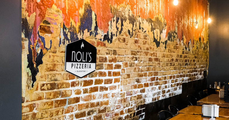 Interior, brick wall with the logo on it