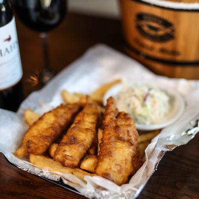 Fish and chips with a side of coleslaw.