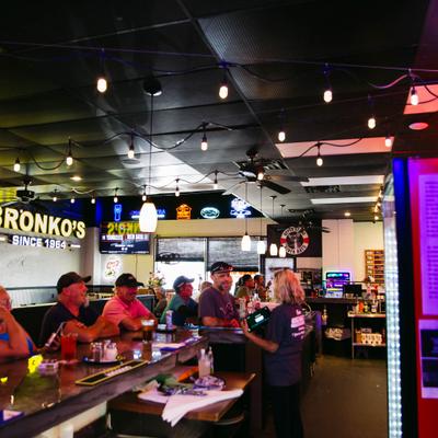 Guests enjoying drinks in a bar with a relaxed atmosphere.