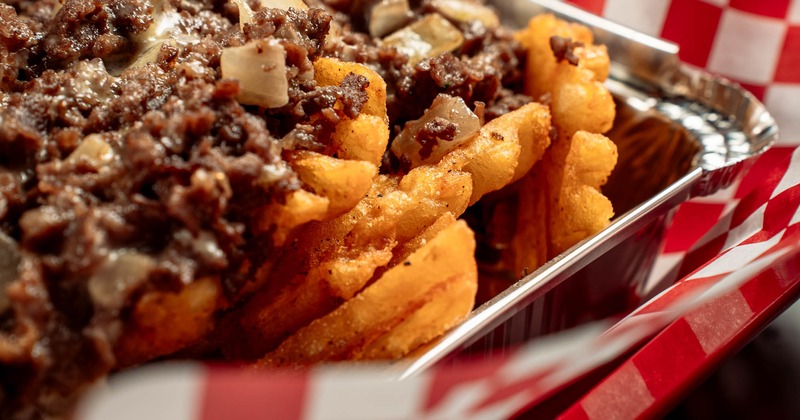 Loaded fries, with ribeye steak, American cheese, and fried onions