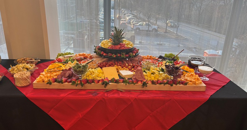 Charcuterie table with fruits, meats, cheeses and condiments