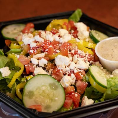 Greek salad topped with crumbled feta and served with house Greek dressing.
