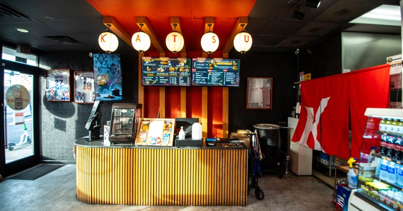 Front counter with menu boards and hanging lanterns