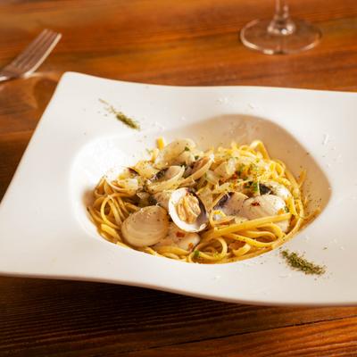 Clam pasta in a white bowl.