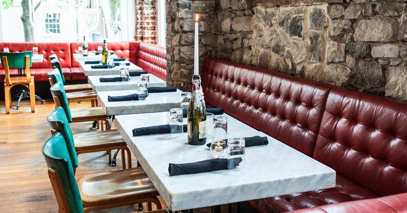 Marble tables, wooden chairs and high back leather seating