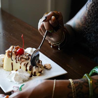 Woman enjoying a dessert, closeup on the dessert. Cannoli cheesecake.