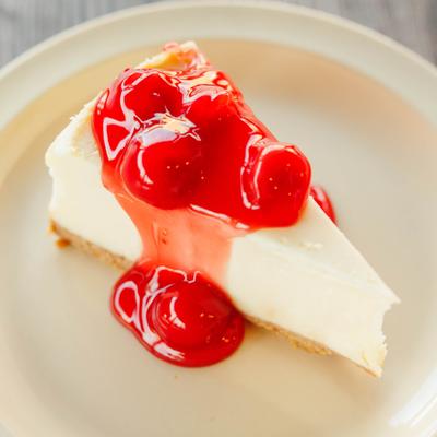 Miss Ann's Famous Cheesecake topped with cherry sauce.