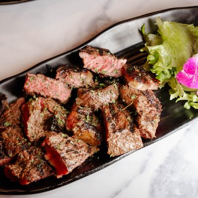 Steak Bites with lettuce on the side.