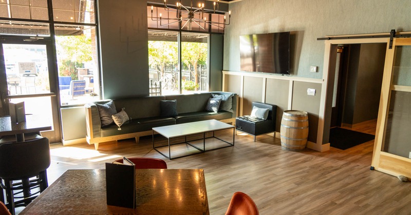 Interior, simulator room, three seater sofa with chair and coffee table, entrance