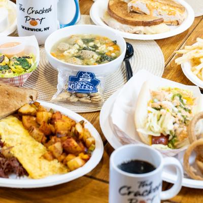 Various dishes served on the table with couple cups of coffee.
