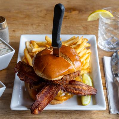 Pacific Coast Western Burger served with fries and a pickle.