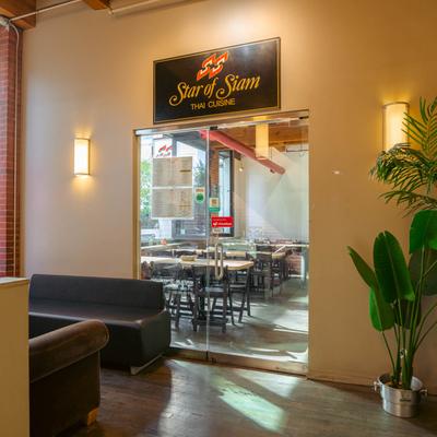 Interior, a small lobby space and glass entrance door with fascia sign above it.