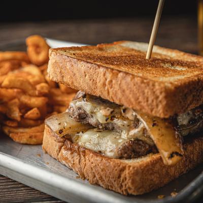 Patty Melt with onion rings.