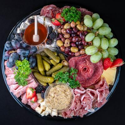 Charcuterie Board, Assorted Meats, Cheeses, Olives, Nuts & Dried ,and Fresh Fruit Garnishes.