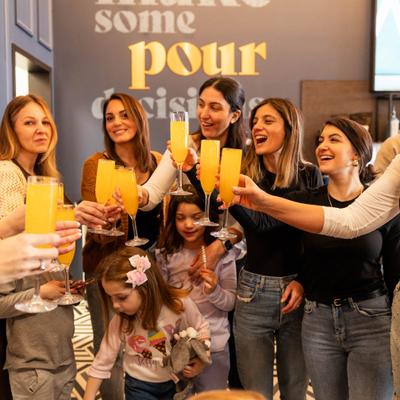 People making a group toast with drinks.