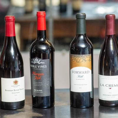 Assorted bottles of red wine.