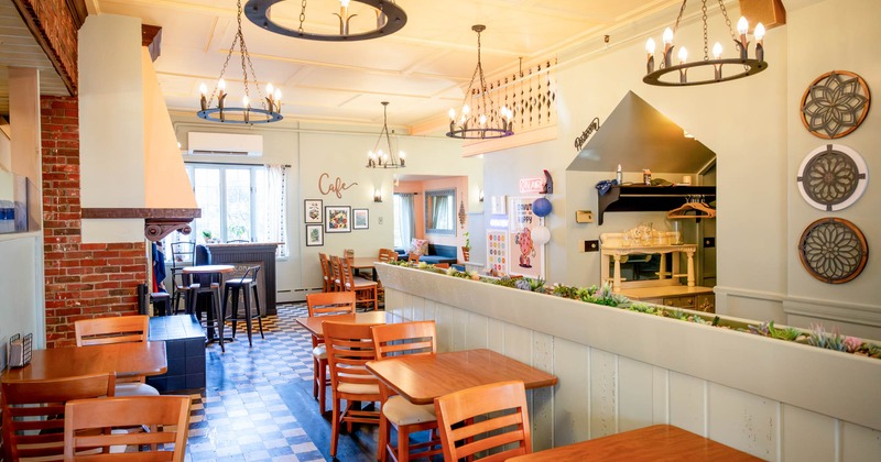 Interior, dining area, wooden top tables for two, checkered tile flooring, wooden room divider
