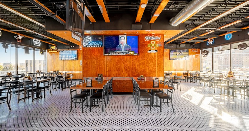 Interior, dining area with a huge TV screen in the middle of the room