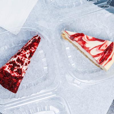 Red velvet cake slice served alongside a slice of Cheesecake.