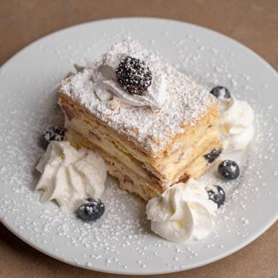 Blueberry Cheese Blintzes with whipped crean, powdered sugar and fresh berries.