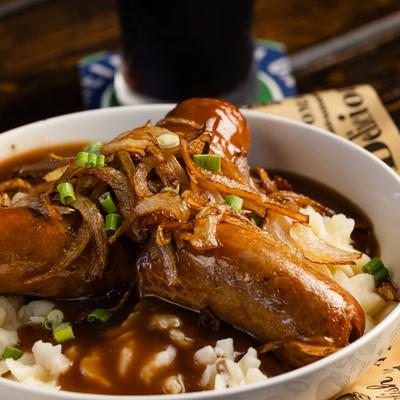 Bangers and mash with gravy and onions.