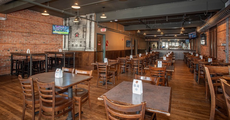 Interior, tables and chairs with bar in the back