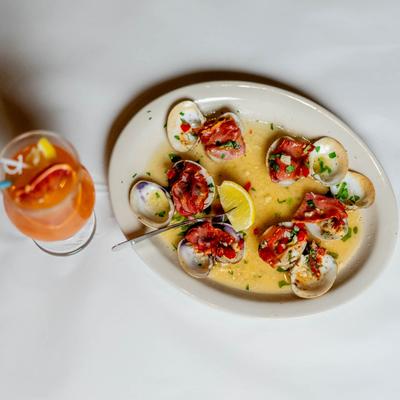 Clams Casino, baked with prosciutto, roasted red peppers, basil, garlic, and white wine.
