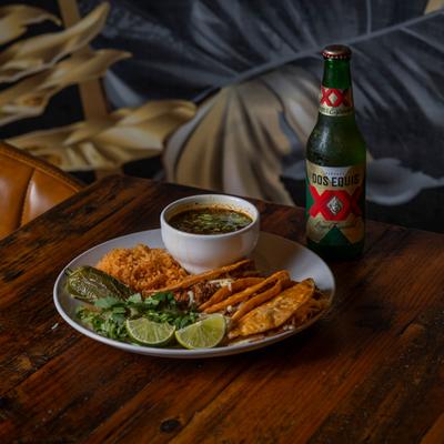 Tacos, served with a drink.