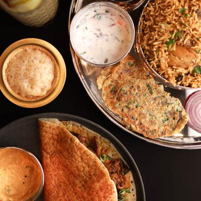 Indian chicken crepe plate and chicken biryani plate, top view.