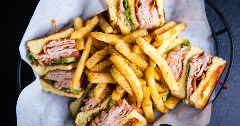 Turkey club sandwiches served with fries