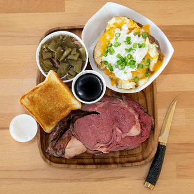 Ribeye dinner with sides of green beans and baked potato.