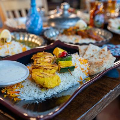 Chicken Shish Kabob with basmati rice, yoghurt, and a vegetable skewer.