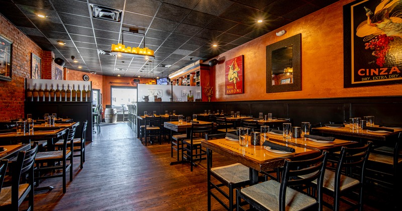 Spacious and cozy interior dining area with wooden chairs and set tables