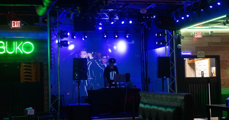 Interior, stage, light effects, DJ performing