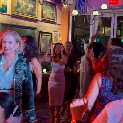 People dancing on the dance floor while the band is playing.