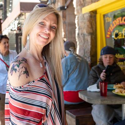 A person sitting outside and smiling.