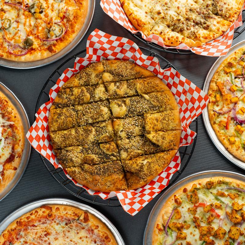 Various pizzas on the table.