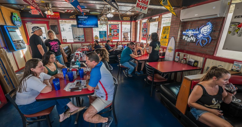 Interior, wide view, people, booths, tables, chairs, banners