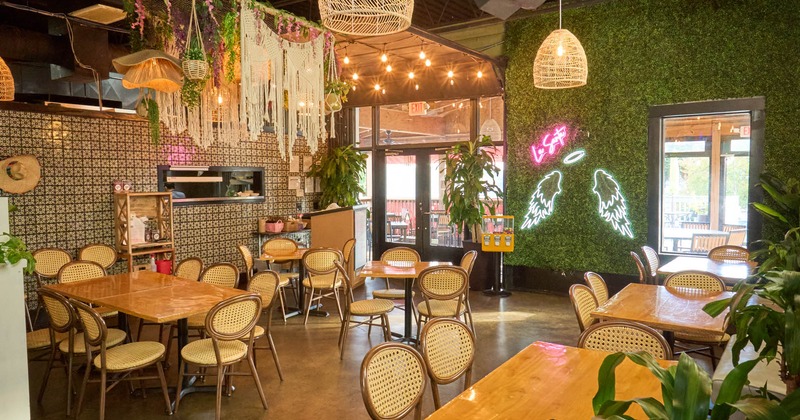 Interior, dining area, tables with chairs, restaurant entrance, artificial grass walls