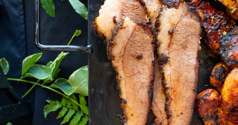 Sliced smoked brisket and wings