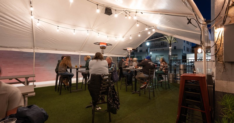 A view of the patio area with guests enjoying food and drinks