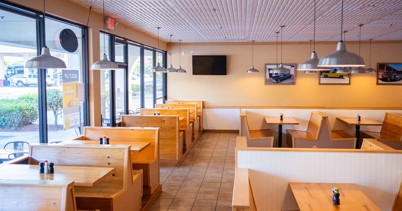 Interior, dining area, tables ready for guests, TV on the wall