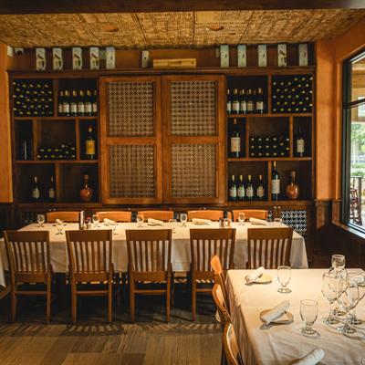 Dining room, table and chairs, wine wall rack behind.