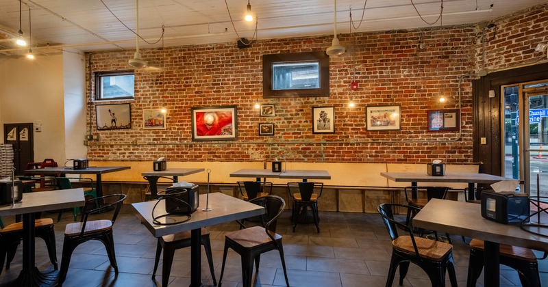 Dining area, tables ready for guests, pictures on the wall