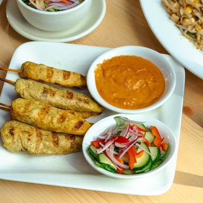 Satay Chicken, peanut sauce and a side of cucumber salad.