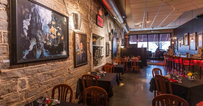 Interior, tables and chairs lined up, pictures on the wall