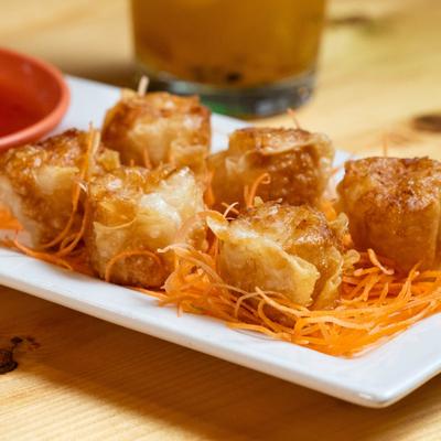Golden fried shumai on shredded carrot.